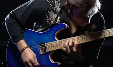 man playing blue Cort electric guitar