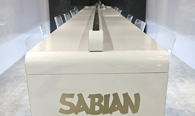chairs atlong white Sabian table in meeting room